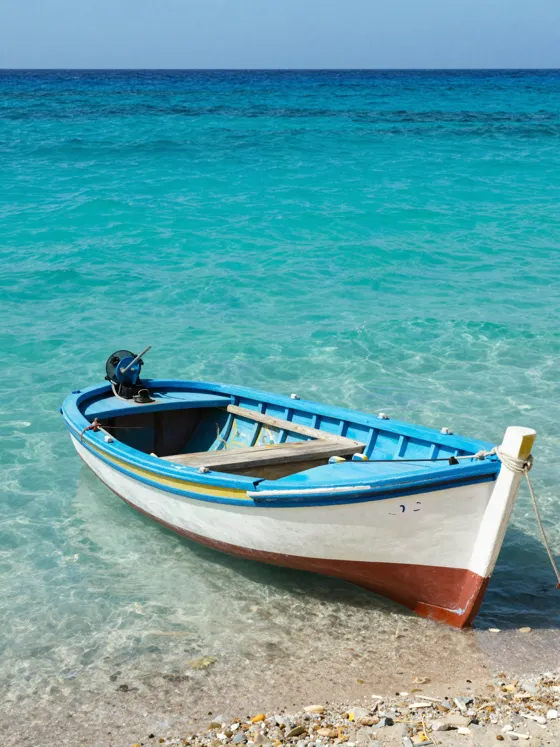 Wooden boat on a turquoise beach
